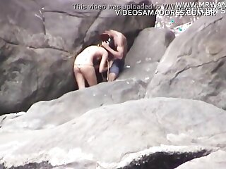 Amateur couple caught having oral sex on the beach in hidden-cam video